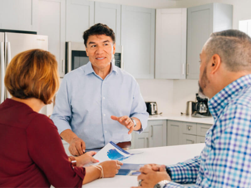 realtor discussing questions couple has about home moving